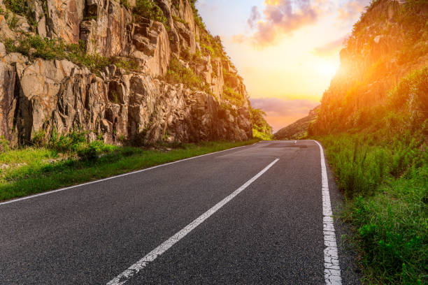 istock Asphalt road and mountain at sunset 1449755701