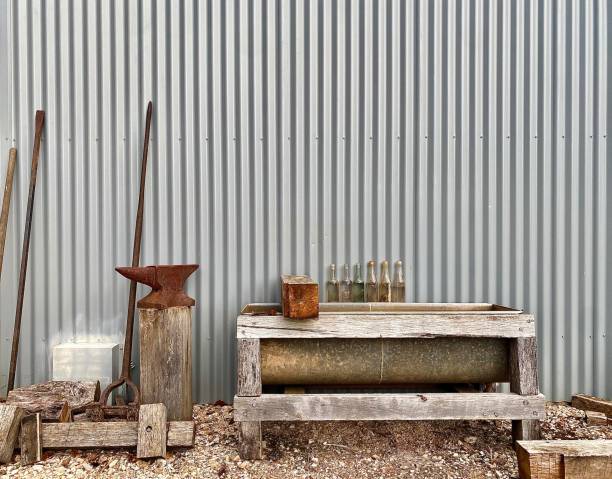 istock Rusted Farm Items Against Corrugated Iron Shed 1449758487