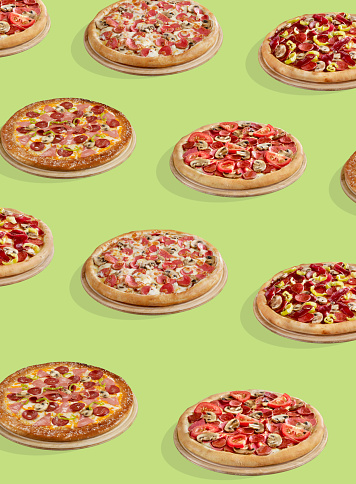 Pizzas in a row on a pastel background
