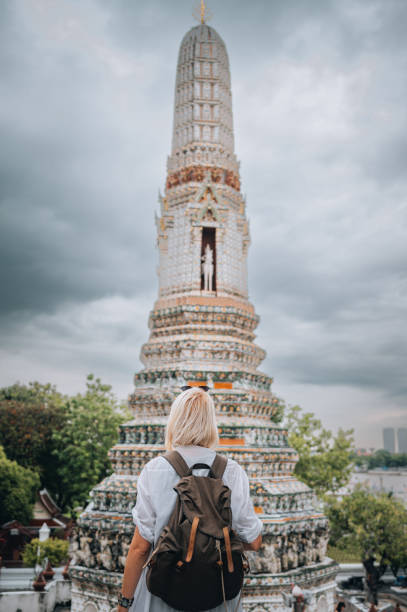 istock Young woman visiting Wat Arun temple 1449765497