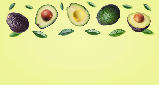 istock Avocado with leaves on a yellow background. 1449766430