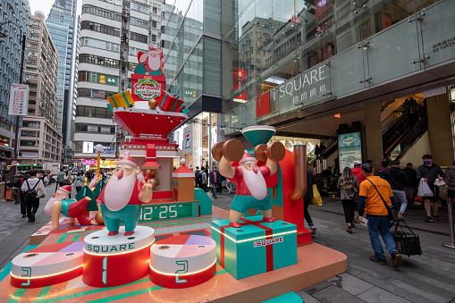 Hong Kong - December 16, 2022 : Pedestrians walk past the Christmas decoration at iSQUARE. It is a 31-storey high shopping complex in Tsim Sha Tsui, Kowloon, Hong Kong.