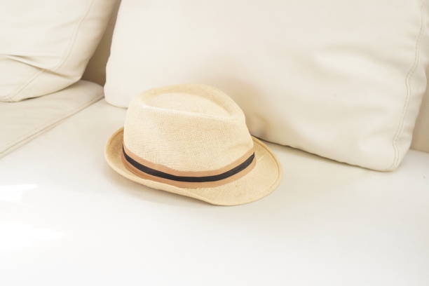 istock The picture shows a white cloth hat placed on a white sofa inside the house. 1449770445