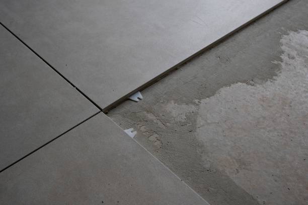 istock High-angle view of a tiled floor with a missing bar creates a gray background 1449771570