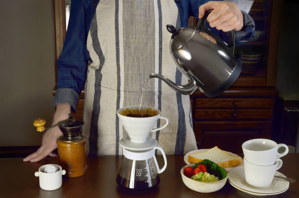 istock Woman Dripping Coffee in the Dining Room 1449774365