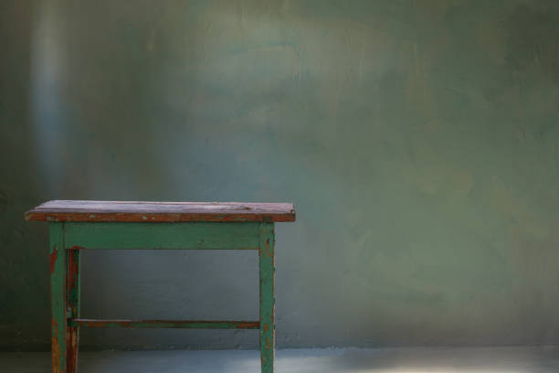 old wooden table on background green old wall
