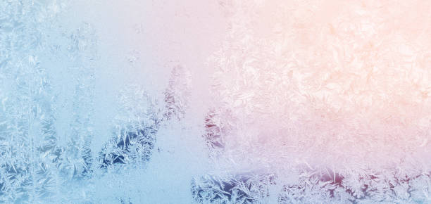 frost on blue glass window background stock photo
