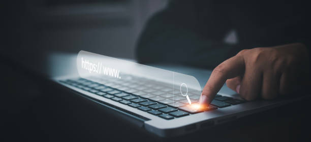 istock Hand  type laptop and Searching Browsing Internet Data Information with blank search bar. man's hands are using smartphone and keyboard to Searching for information. Using Search Console with website. 1449779185