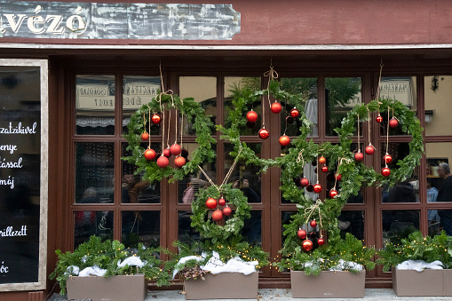 Szentendre, Hungary - November 30th, 2022: Christmas decorations on a restaurant window on a Szentendre, Hungary, street.