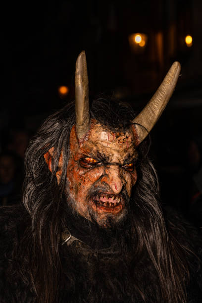Cesky Krumlov, Czech Republic - December 4 2022: Krampus or Cert Demonic Figure with Horned Mask at a Traditional Bohemian Krampus Run on Saint Nicholas Day in Czechia.