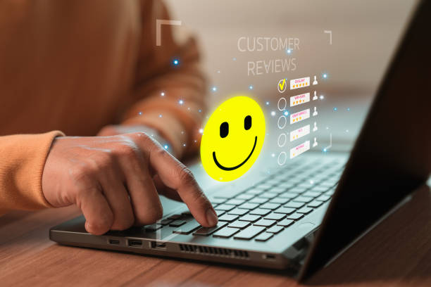 istock Man hand using computer laptop with popup five star icon for feedback review satisfaction service, testimonial. Customer service experience and business satisfaction survey. 1449787249