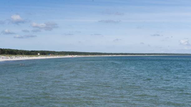 istock Sea coastline across blue water under clear sky 1449788066