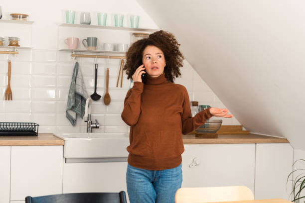 istock Girl talking on mobile phone at home 1449788117