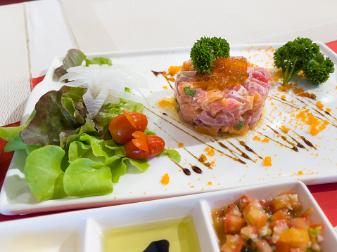 Tuna tartar plate with salad and tomato dip. Traditional Japanese restaurant food concept