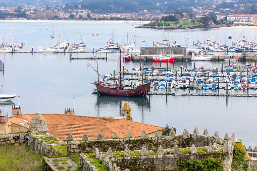 Baiona, Spain - December 05, 2022: port of Baiona with a replica of the caravel La Pinta of Christopher Columbus in Baiona, Spain