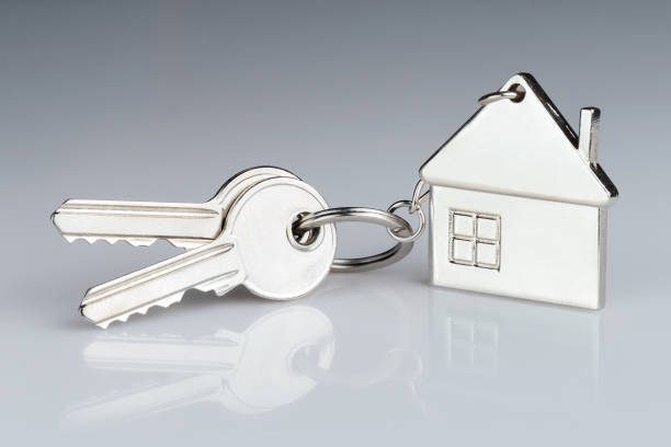 istock House keys with house shaped keychain on gray 1449792090