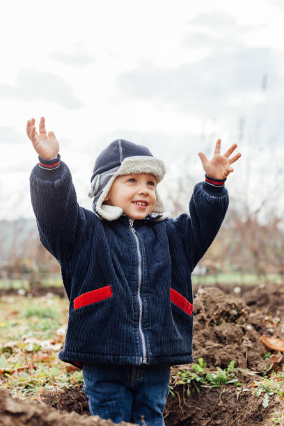istock Happy kid in the hole for planting seedlings 1449794083