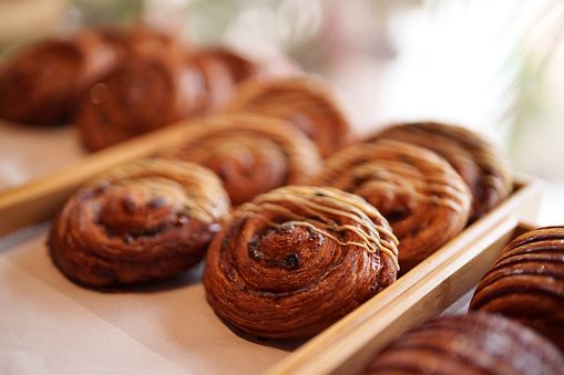 Close-up on delicious Pain au Raisin & Cinnamon at a pastry shop
