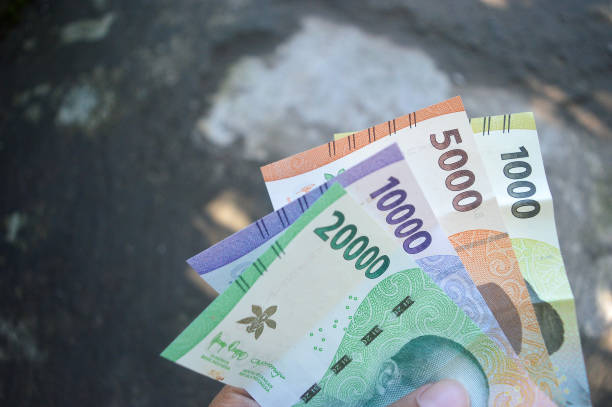 istock One thousands, Five thousands, ten thousands, twenty thousands rupiah banknote, Indonesia new paper currency on hand 1449795481