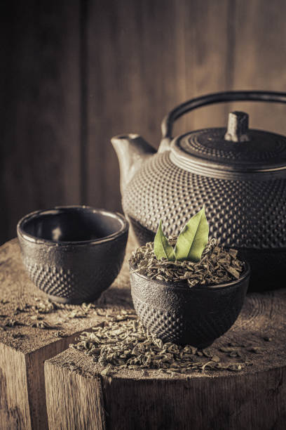 istock Delicious and healthy green tea with iron teapot and cup. 1449798917