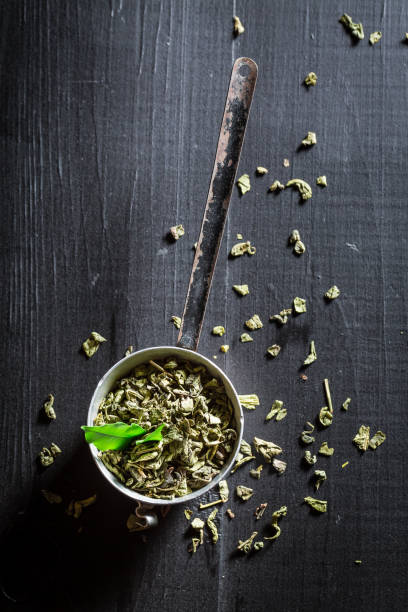 istock Tasty and fresh green tea on wooden table. 1449799040