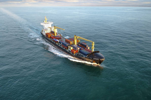 istock Nice aerial view of a container ship sailing at dawn 1449803039