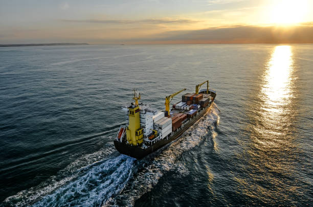 istock Nice aerial view of a container ship sailing at dawn 1449803108