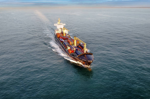 istock Nice aerial view of a container ship sailing at dawn 1449803425