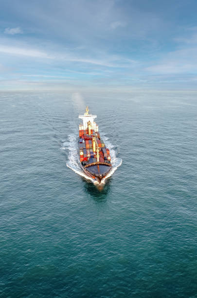 istock Nice aerial view of a container ship sailing at dawn 1449803566