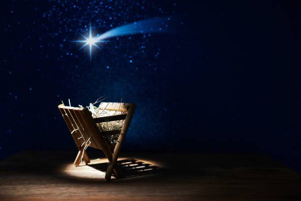 Nativity of Jesus, empty manger at night with bright lights