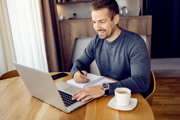 istock A happy man following online course on a laptop from home. 1449806233
