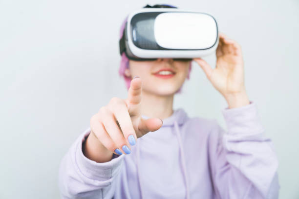 istock Young woman watching movie using virtual reality glasses 1449807028