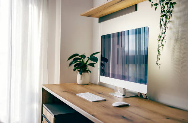 istock A workstation at home. Minimalistic home office with desk and computer on it. 1449807121