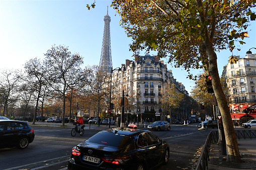 Paris, France-12 16 2022: Parisian street scene and the Eiffel tower in the background, France.
