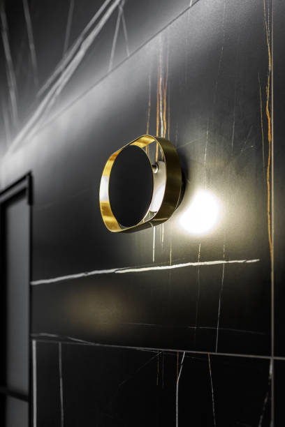 Wall lamp illuminated black wall with textured wallpaper, spotlight background