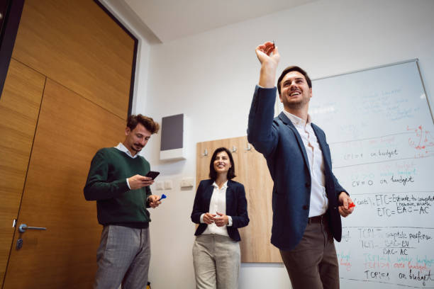 istock Business people playing darts at the office and having fun together 1449810098