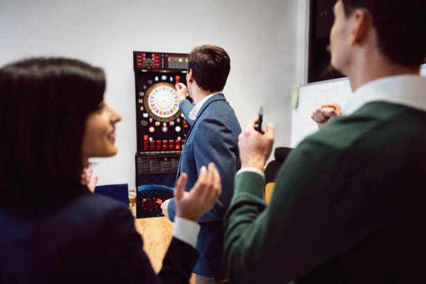 istock Business people playing darts at the office and having fun together 1449810103