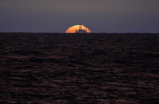 Industrial oil rig offshore platform construction site on the North Seacoast. The fossil fuel is in a crisis, and renewable energy is the future