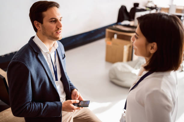 istock Two colleagues discussing business at their workplace 1449810869