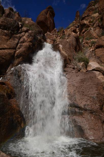 istock Cascade of a waterfall flowing from a rocky cliff 1449812228