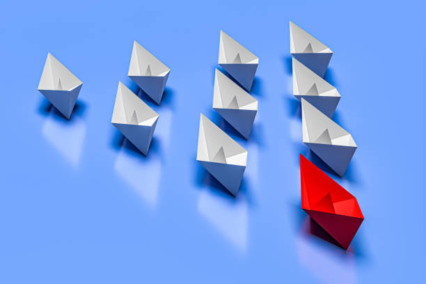 istock Leadership and business concept. One red leader ship leads other ships forward 1449813373