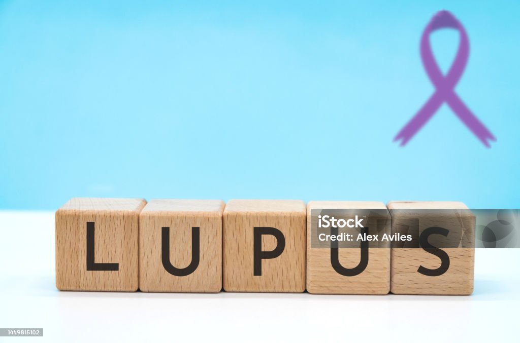 lupus day lupus text concept with letters on wooden block cubes on blue background with copy space Systemic Lupus Erythematosus Stock Photo