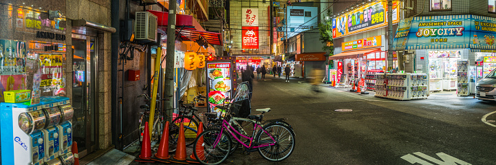 Neon lights and crowded streets of DenDen Town at night in the heart of Osaka, Japan’s vibrant second city.