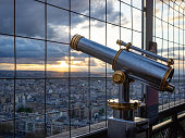 Parisian cityscape with spyglass from Eiffel Tower viewpoint. View of Seine River with bridges and Ile aux Cygnes.