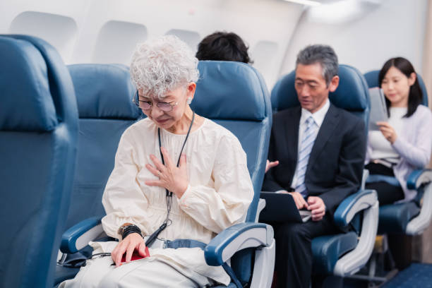 istock Elderly Woman Suffering from Illness on Airplane 1449816321