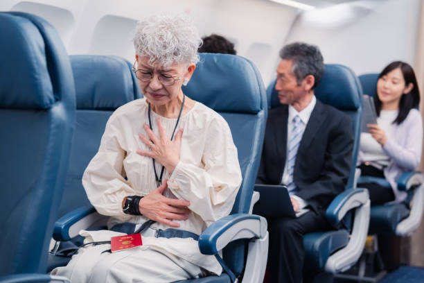 istock Elderly Woman Suffering from Illness on Airplane 1449816324