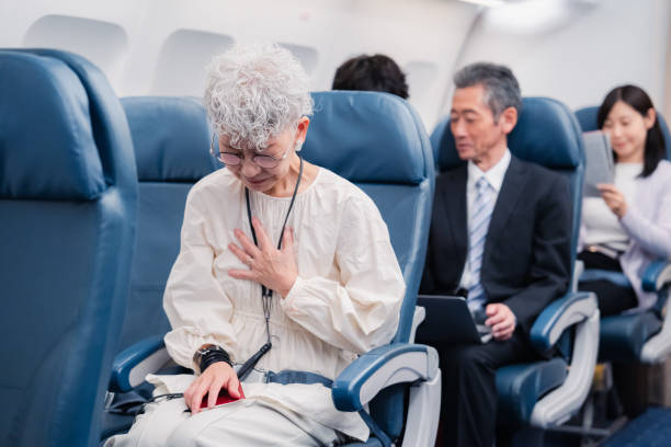 istock Elderly Woman Suffering from Illness on Airplane 1449816325