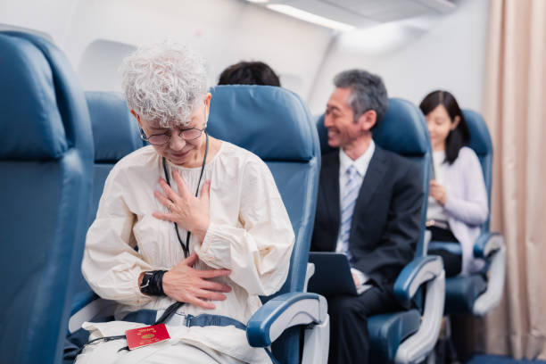 istock Elderly Woman Suffering from Illness on Airplane 1449816330