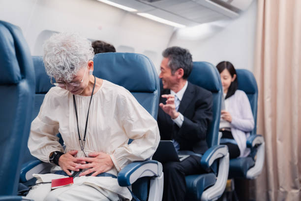 istock Elderly Woman Suffering from Illness on Airplane 1449816334