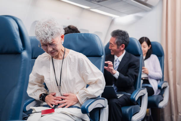 istock Elderly Woman Suffering from Illness on Airplane 1449816337
